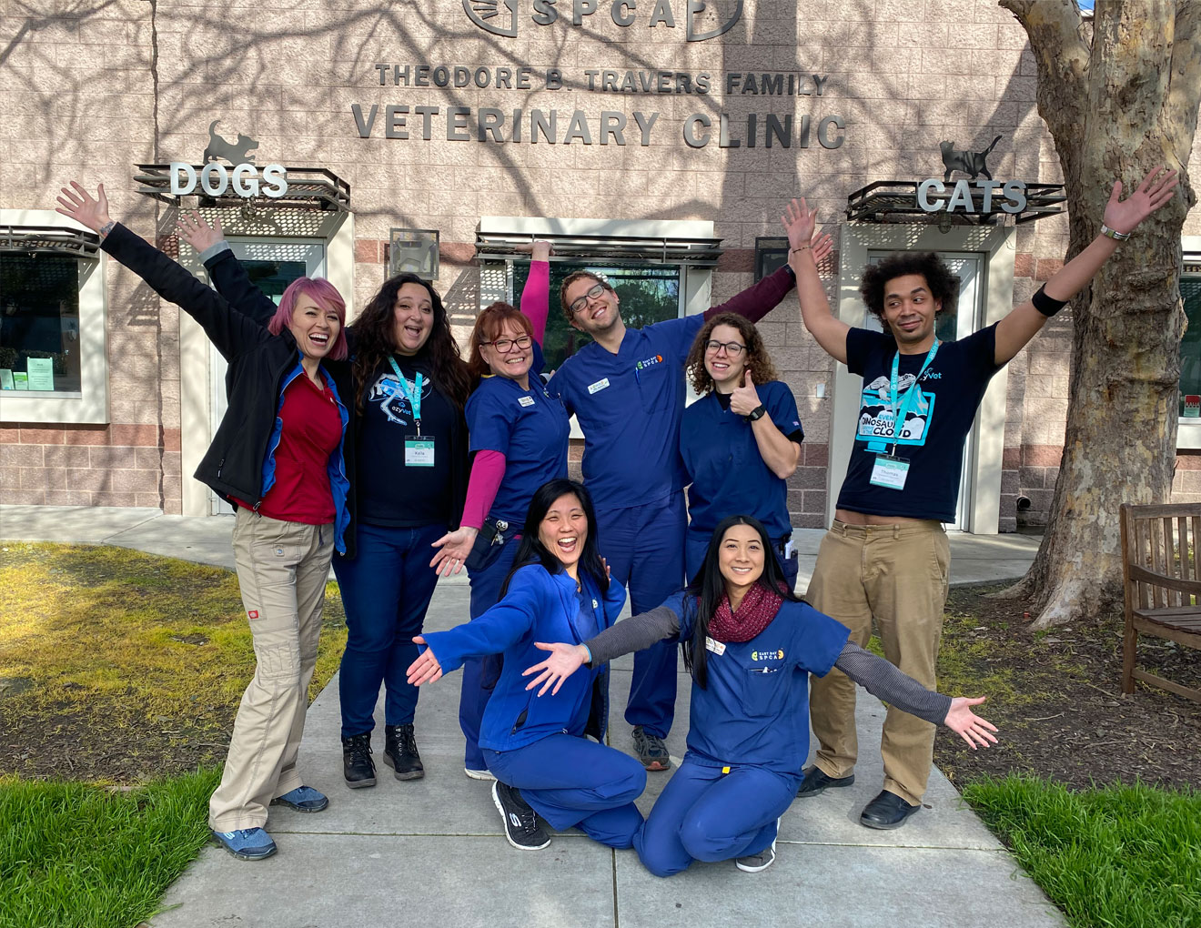 Vet clinic staff in front of building.